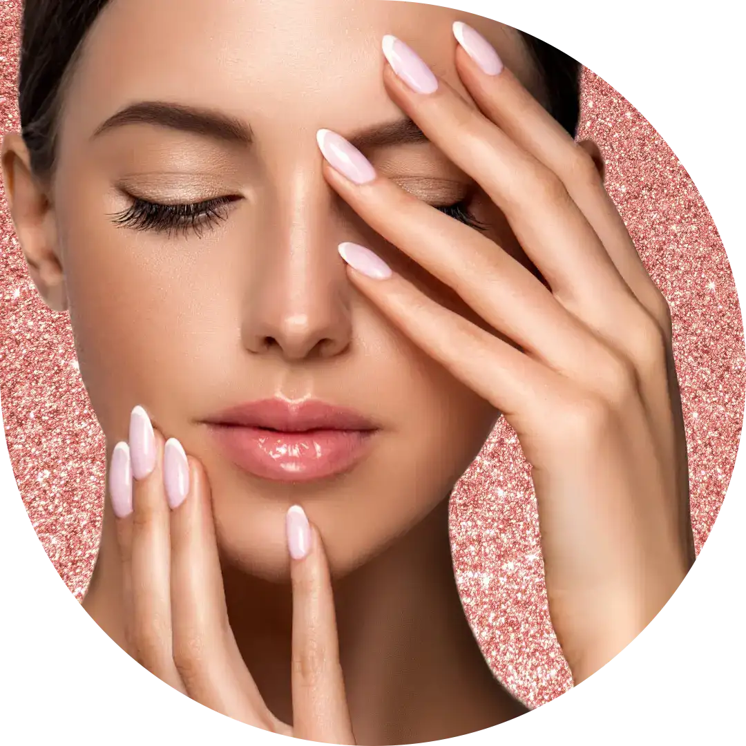 Woman holds her hands to her face showing off fingernails.